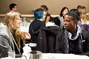 Two attendees talk at the mentoring breakfast